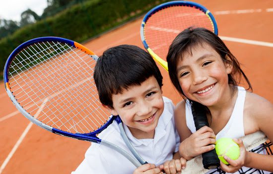 Boy and girl on a tennis court