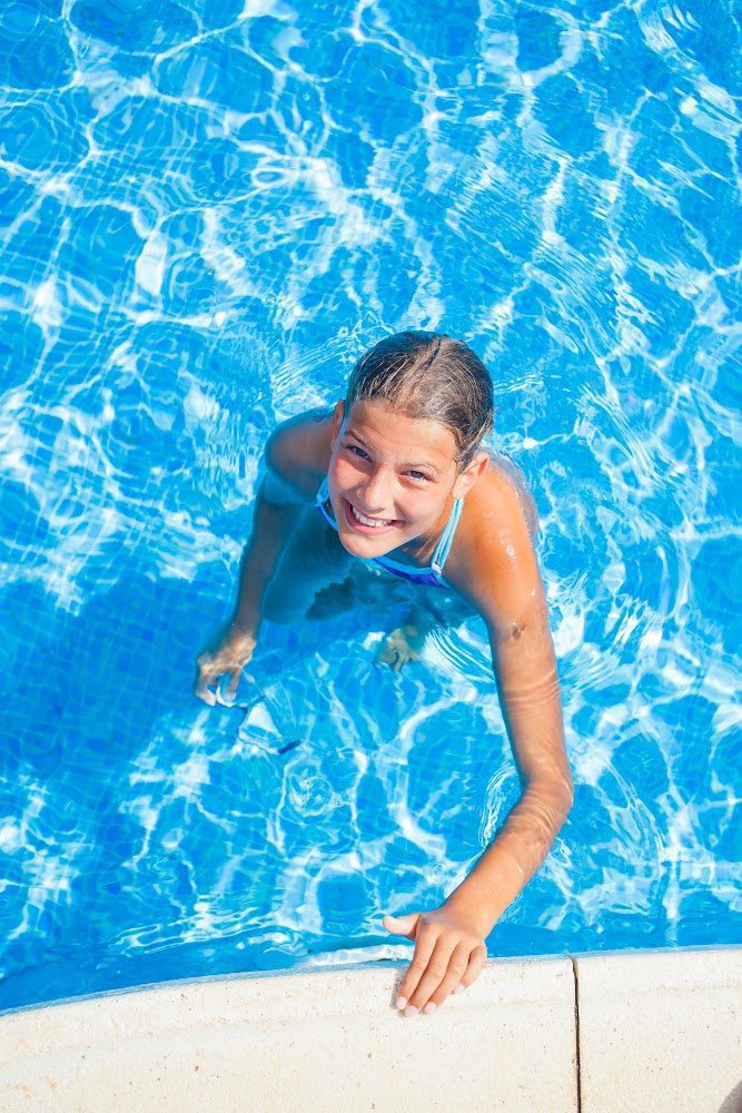 Young girl swimming in pool